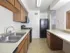 Kitchen with tile floors and modern appliances at Victoria Crossing Apartments in Reading, PA.