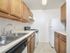 Model kitchen with tiled floors, wood cabinets and modern appliances at Woodland Plaza Apartments in Wyomissing, PA.
