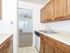 Model kitchen with tiled floors, wood cabinets and modern appliances at Woodland Plaza Apartments in Wyomissing, PA.