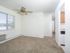 Dining area with a large window and ceiling fan looking into the kitchen at Woodland Plaza Apartments in Wyomissing, PA.