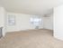 Carpeted living area with staircase to the apartment entrance at Woodland Plaza Apartments in Wyomissing, PA.