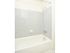 Model bathroom with tiled tub shower at Woodland Plaza Apartments in Wyomissing, PA.