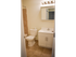 Model bathroom with vanity sink, toilet and tiled tub shower at Willow Ridge Apartments in Marlton, NJ.