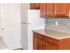 Small kitchen with brown cabinets and contemporary tiled backsplash