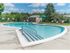 Community swimming pool with lounge chairs on the sundeck at Park City apartments in Lancaster, PA.