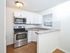 Renovated modern kitchen with breakfast bar and white cabinets