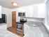 Kitchen with grey countertops and contemporary backsplash in apartment for rent in Phoenixville, PA