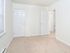 Large bedroom with white walls and closet
