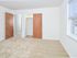 Large window letting in lots of natural light to spacious apartment bedroom