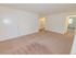 Carpeted living room looking towards the bedroom at Mill Creek Village apartments in Langhorne, PA.