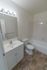 Model bathroom with vanity sink, toilet and tub shower at Oak Forest Apartments in Reading, PA.