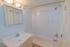 Bathroom with a cabinet and white tile at Allandale Village apartments for rent
