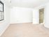 Spacious bedroom with large window and beige carpeting