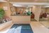 Lobby of the leasing office with reception counter and seating areas at Whiteland West Apartments in Exton, PA.