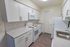 Model kitchen with wood-style flooring with modern appliances at Whiteland West Apartments in Exton, PA.