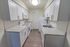 Model kitchen with wood-style flooring with modern appliances at Whiteland West Apartments in Exton, PA.