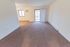 Carpeted living room with sliding glass balcony doors at Whiteland West Apartments in Exton, PA.