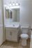 Tiled bathroom with vanity sink and toilet at Whiteland West Apartments in Exton, PA.