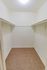 Walk-in closet with clothes bar and shelf at Whiteland West Apartments in Exton, PA.