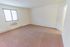 Carpeted bedroom with a window and in-wall air conditioning unit at Whiteland West Apartments in Exton, PA.