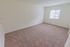 Bedroom with beige carpet and a window at Caln East apartments for rent