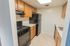 Model kitchen with tiled floors and modern black appliances at Park Court Apartments in Reading, PA.