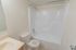 Model bathroom with vanity, toilet and tub shower at Park Court Apartments in Reading, PA.