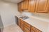 Model kitchen with wood cabinets and modern appliances at Park Court Apartments in Reading, PA.