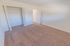 Bedroom with beige carpet and a closet at Black Hawk apartments for rent