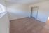 Bedroom with beige carpet and a closet at Black Hawk apartments for rent