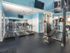 Fitness center with 3 treadmills and weight machines at Waterloo Place Apartments in Baltimore, MD.
