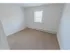 Large windows in a carpeted bedroom at Mayflower Crossing Apartments in Wilkes-Barre, PA.