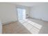 Carpeted living room with sliding patio door at Mayflower Crossing Apartments in Wilkes-Barre, PA.