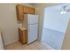 Kitchen with tiled flooring and modern appliances at Mayflower Crossing Apartments in Wilkes-Barre, PA.