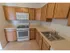 Kitchen with tiled flooring and modern appliances at Mayflower Crossing Apartments in Wilkes-Barre, PA.