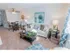 Furnished sample living room with a couch and coffee table and dining area with a circle table and 4 chairs at Mayflower Crossing Apartments.