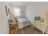 Model bedroom furnished with a large bed, dresser and nightstand at Mayflower Crossing Apartments in Wilkes-Barre, PA.