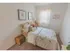Model bedroom furnished with a large bed, dresser and nightstand at Mayflower Crossing Apartments in Wilkes-Barre, PA.