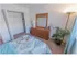 Model bedroom furnished with a large bed, dresser and nightstand at Mayflower Crossing Apartments in Wilkes-Barre, PA.
