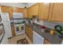 Kitchen with tiled flooring and modern appliances at Mayflower Crossing Apartments in Wilkes-Barre, PA.