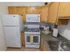 Kitchen with tiled flooring and modern appliances at Mayflower Crossing Apartments in Wilkes-Barre, PA.