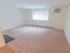 Large living room with carpet flooring and sizable window