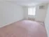 Carpeted bedroom with sizable window and white walls