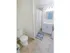 Large bathroom with tile flooring and white sink and vanity
