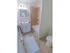 Spacious bathroom with tiled shower and white sink and vanity