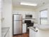 Model kitchen with wood-style floor and stainless-steel appliances at Willow Ridge Apartments in Marlton, NJ.