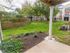 Cement patio with landscaping around the edges at at Spring House Apartments in Laurel, MD.