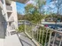 Balcony overlooking the landscaped grounds and parking area at The Lafayette at Valley Forge apartments in King of Prussia, PA.