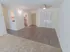 Carpeted living room and dining area with wood-style flooring at The Lafayette at Valley Forge apartments in King of Prussia, PA.