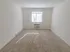 Carpeted bedroom with a window and in-wall A/C unit at The Lafayette at Valley Forge apartments in King of Prussia, PA.
